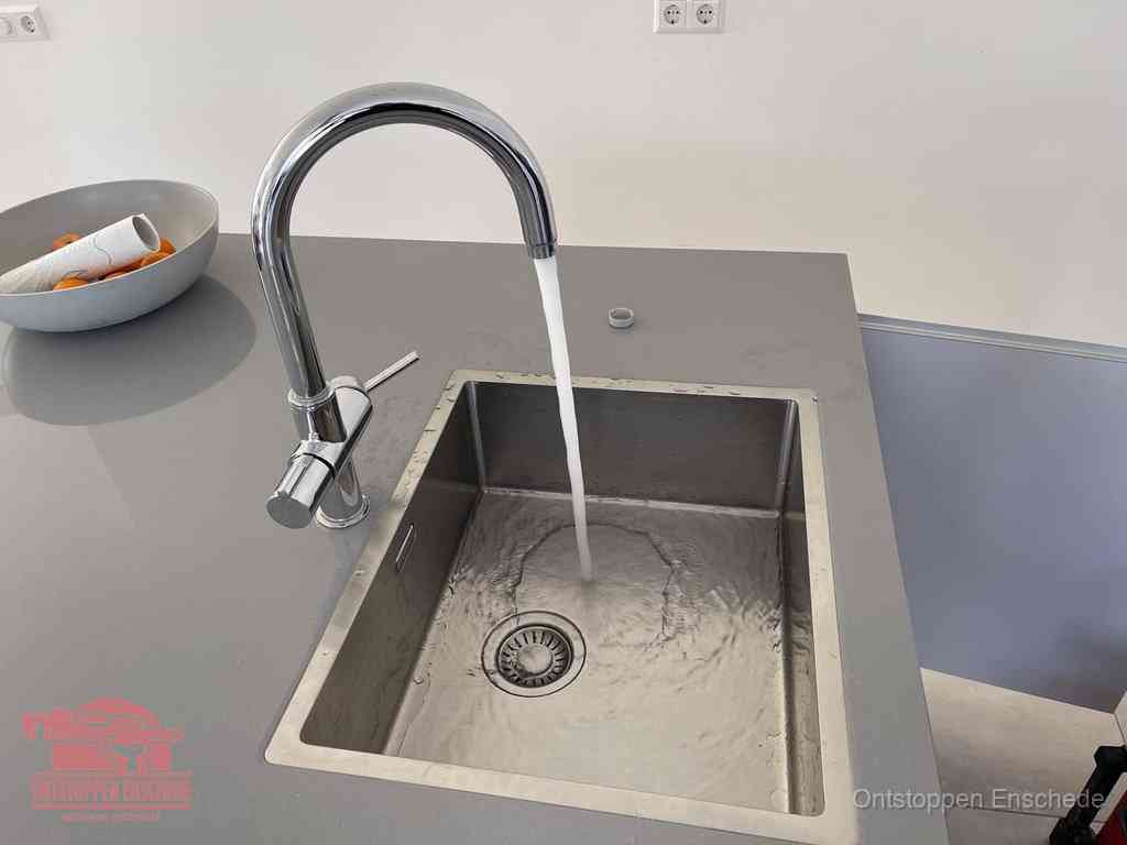 Een vrij doorstromende rvs spoelbak waar het water moeiteloos wegloopt, het resultaat van slim onderhoud dat geld bespaart in Enschede
