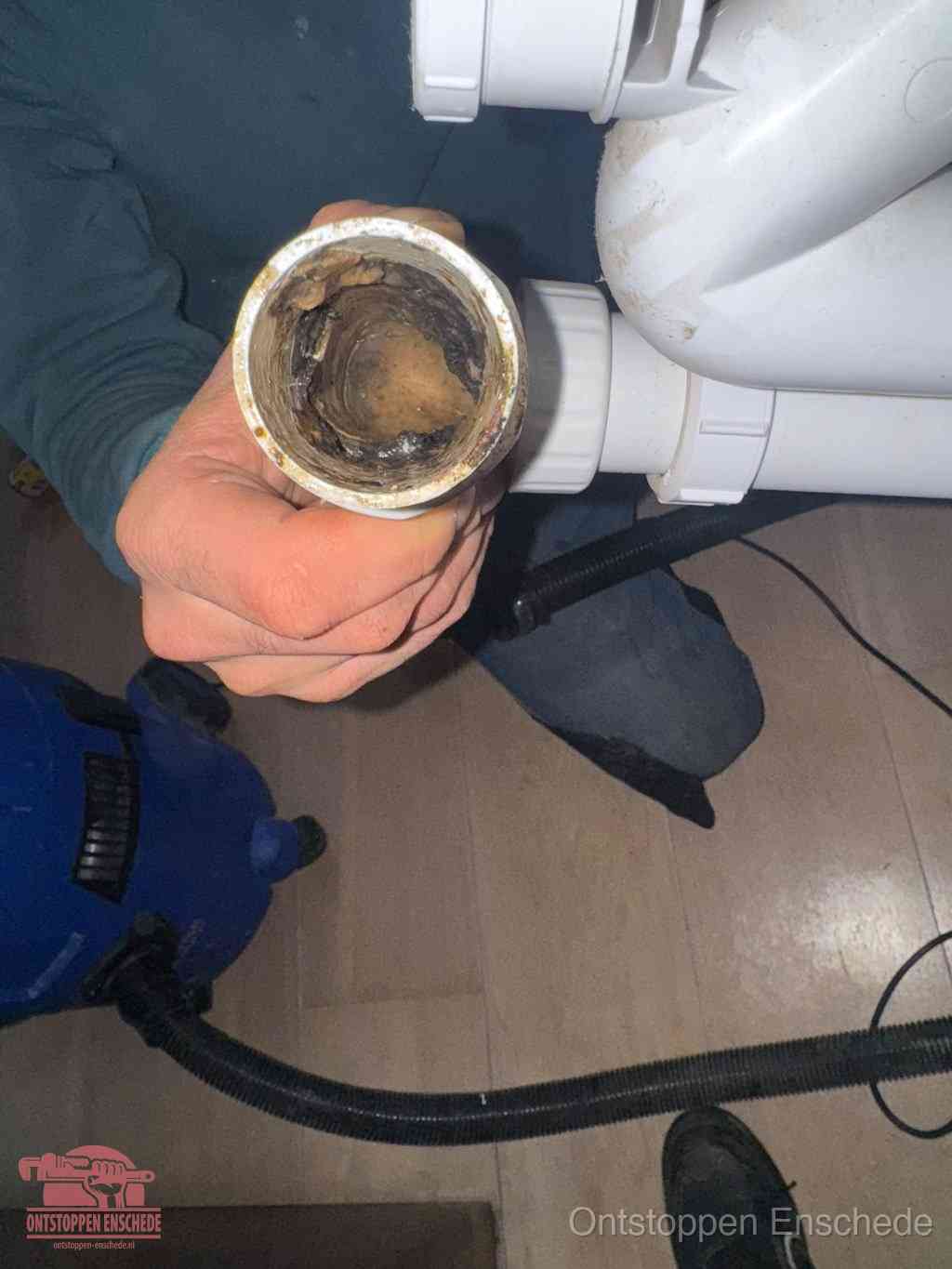Een losgekoppeld afvoerbuisstuk dat van binnen volledig is dichtgeslibd, het gevolg van een verstopping te lang laten zitten in Enschede